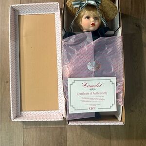 Camelot Collectible Porcelain Doll with Emerald Outfit and straw Hat with bow.